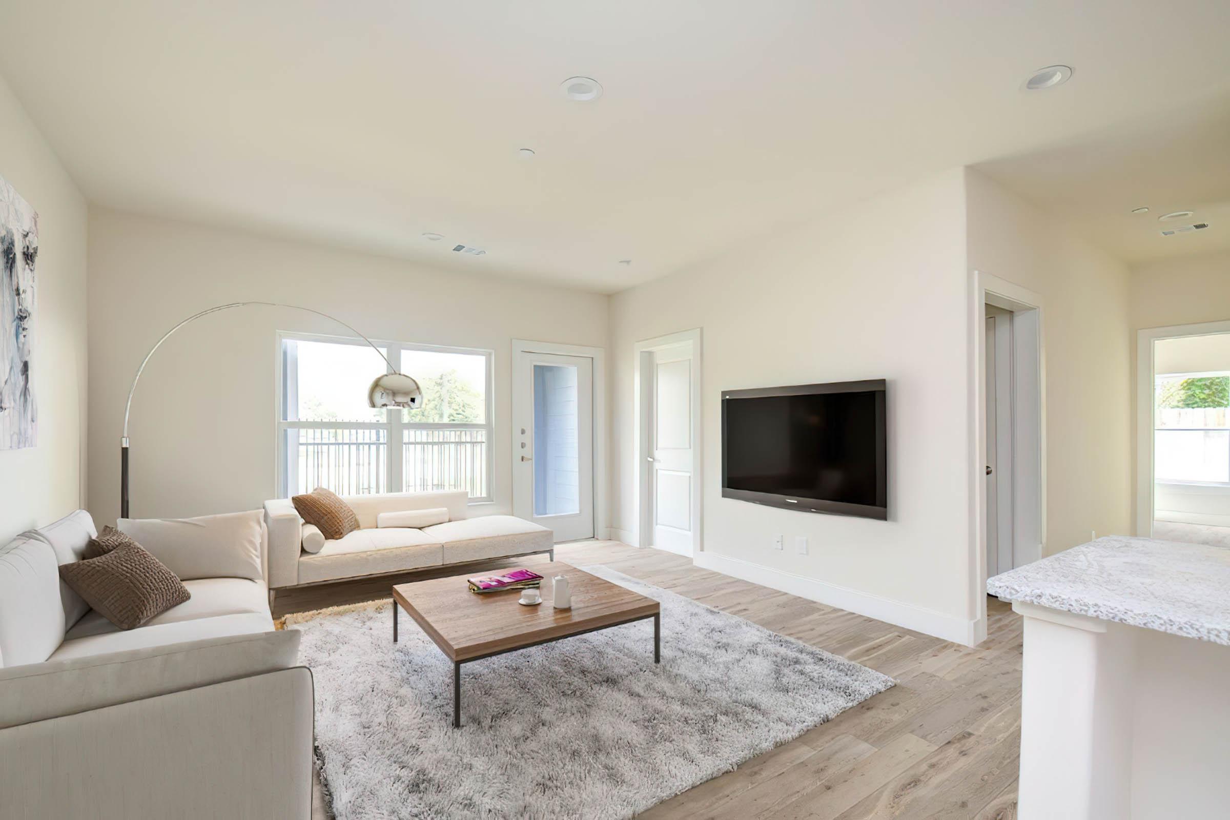 a living room filled with furniture and a large window