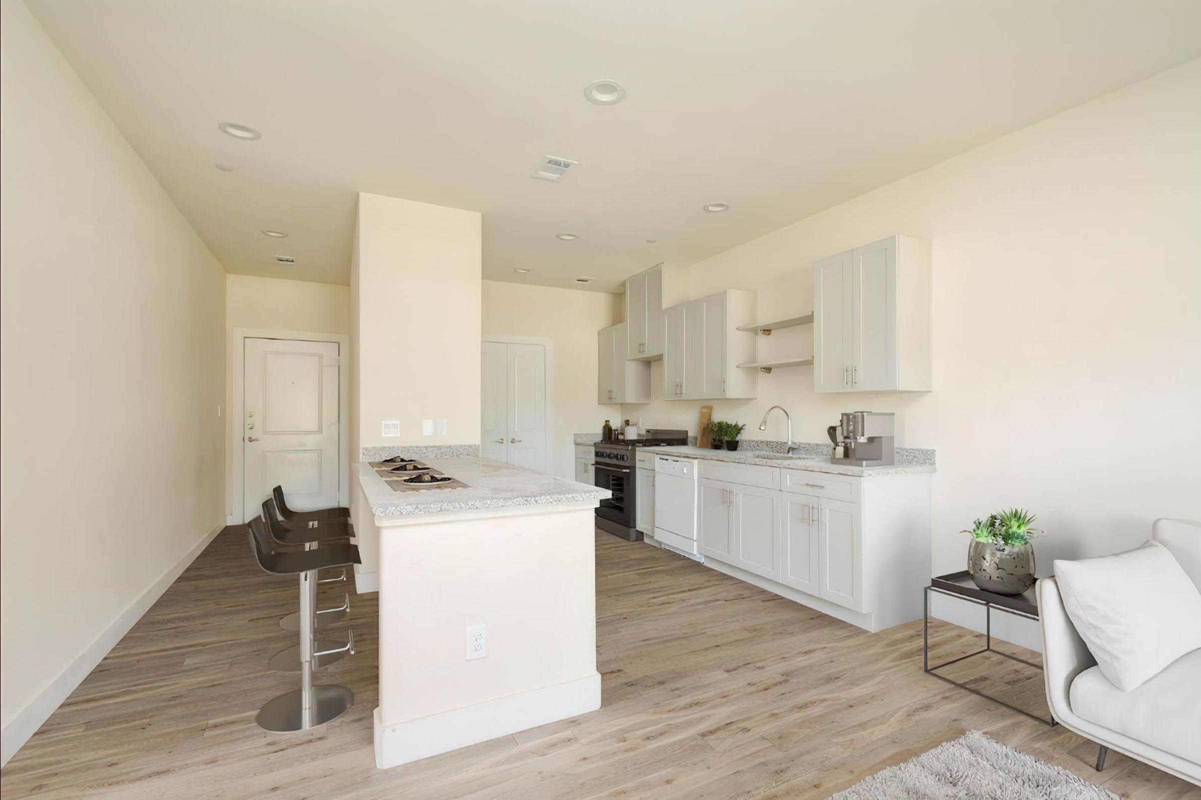 a living room filled with furniture and a sink