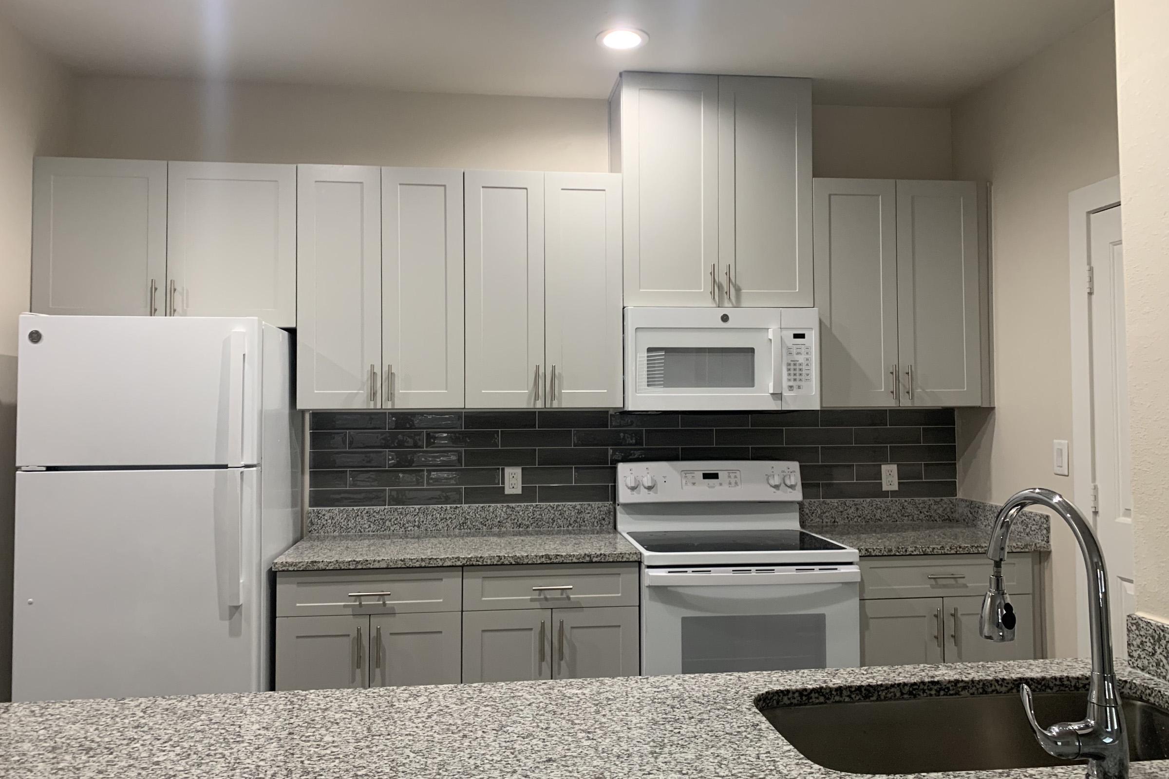 a kitchen with a sink and a refrigerator