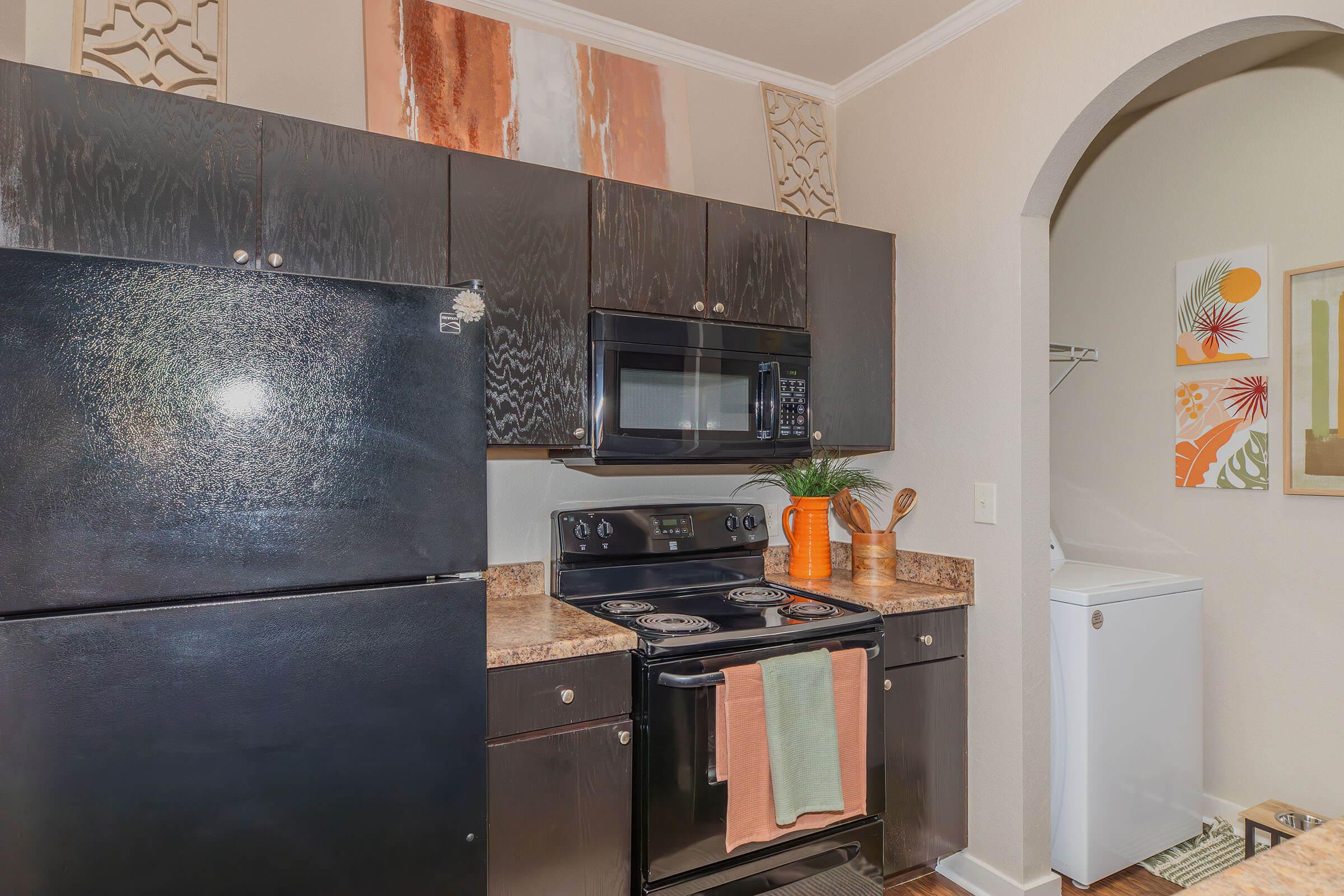 a stove top oven sitting inside of a kitchen