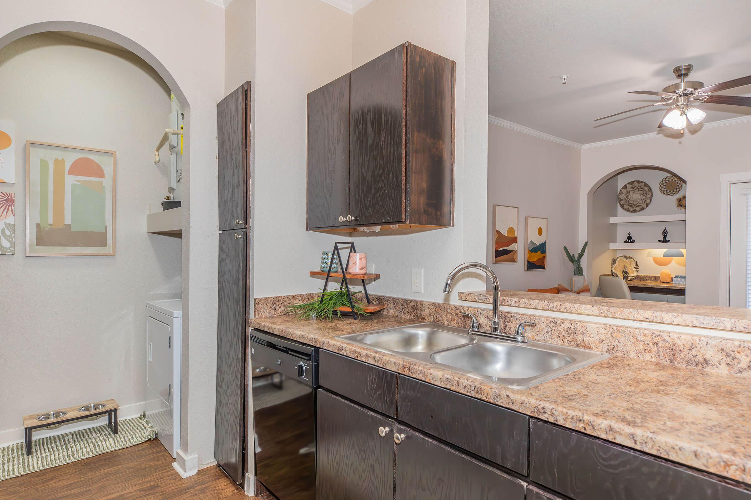 a kitchen with a sink and a mirror