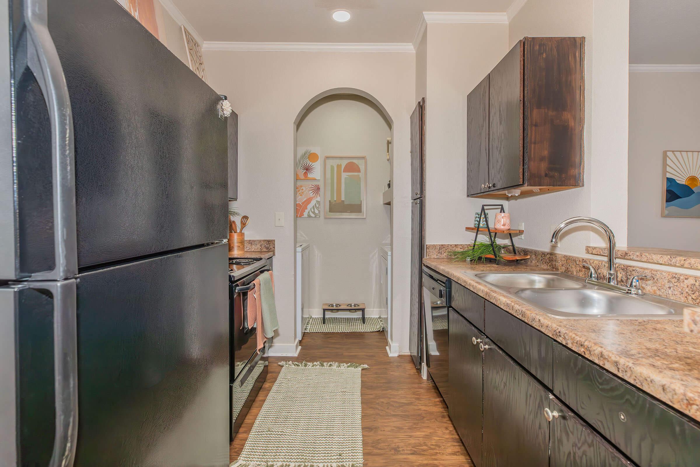 a kitchen with a sink and a refrigerator