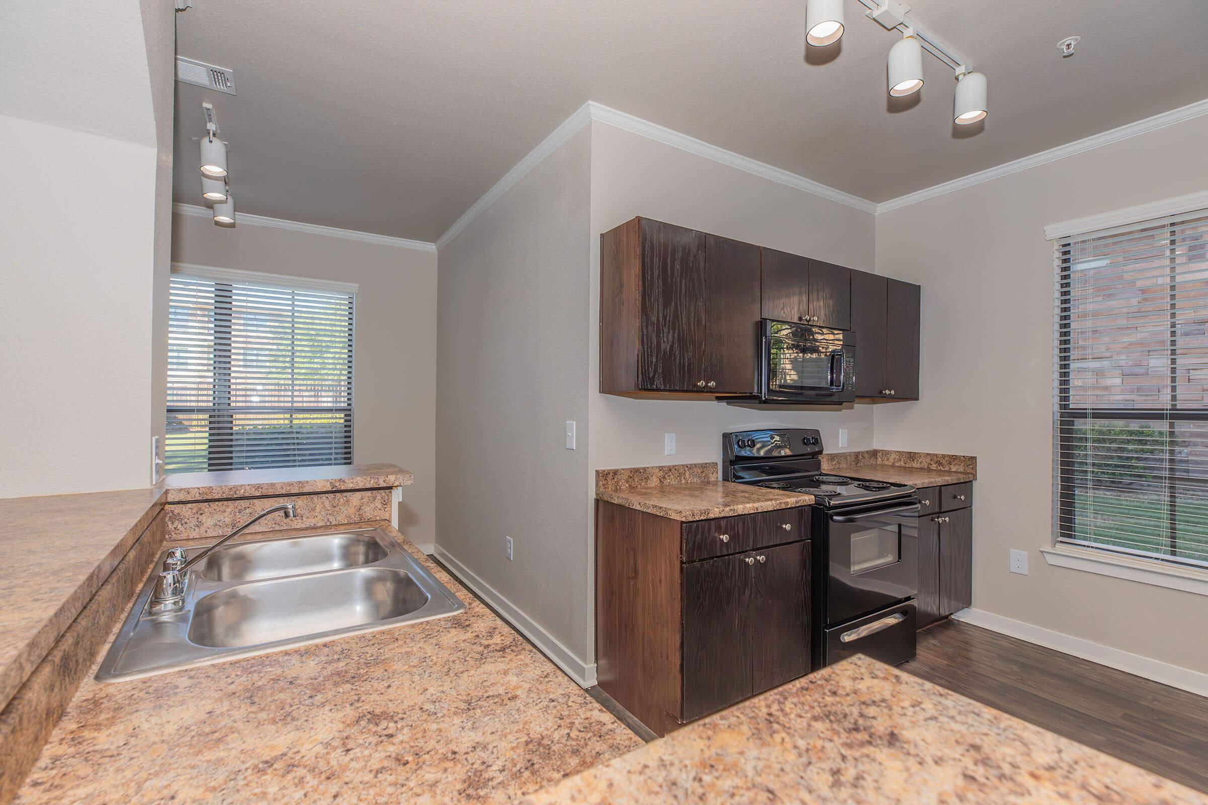 a kitchen with a sink and a window