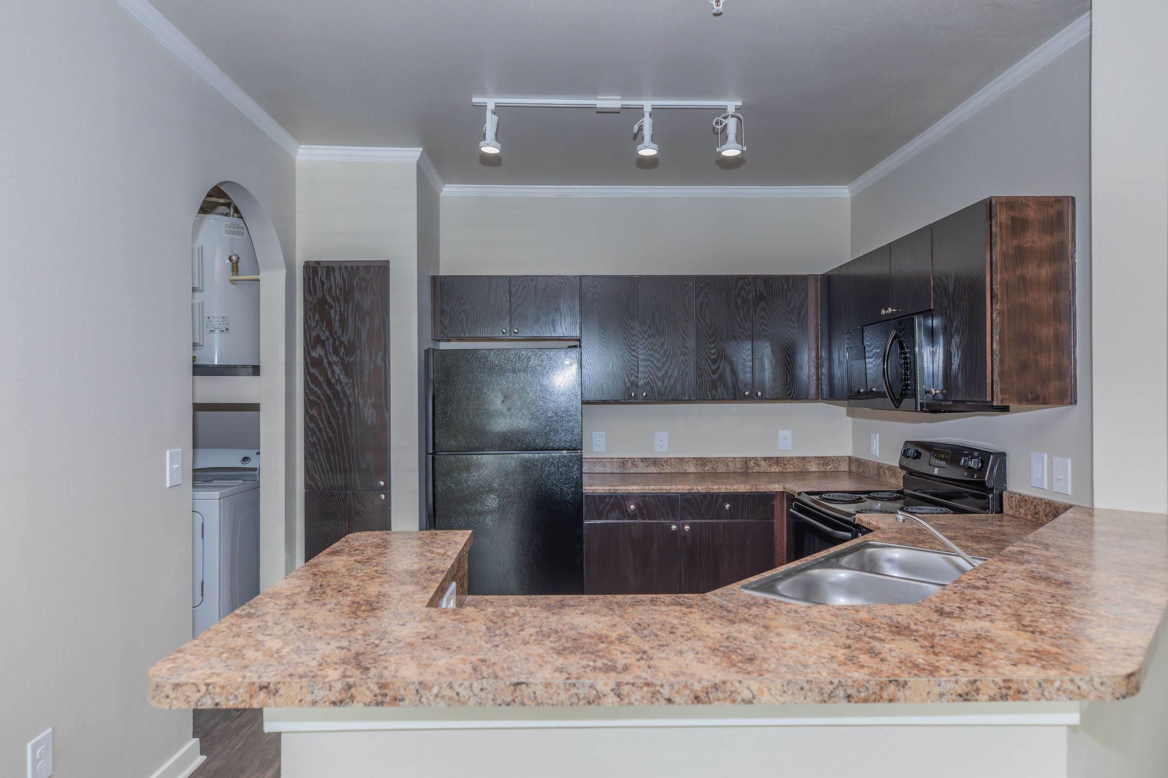 a kitchen with a sink and a mirror