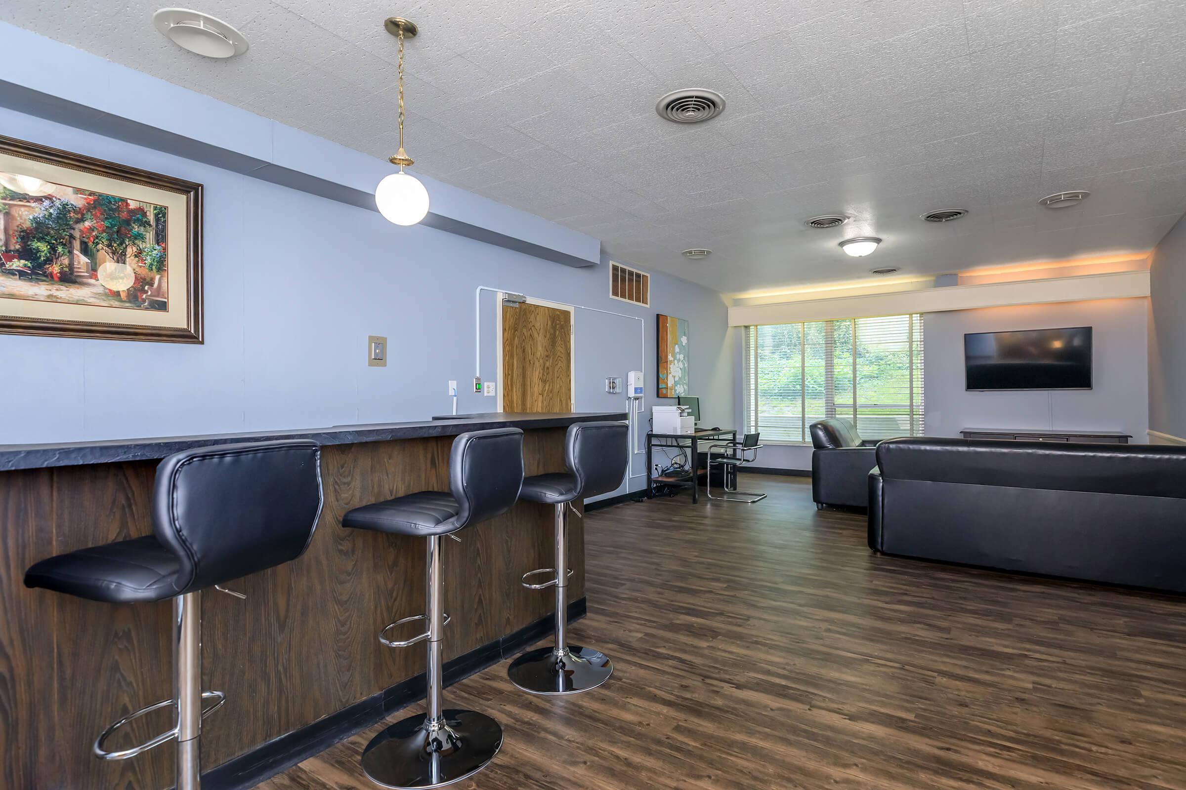 a living room filled with furniture and a tv