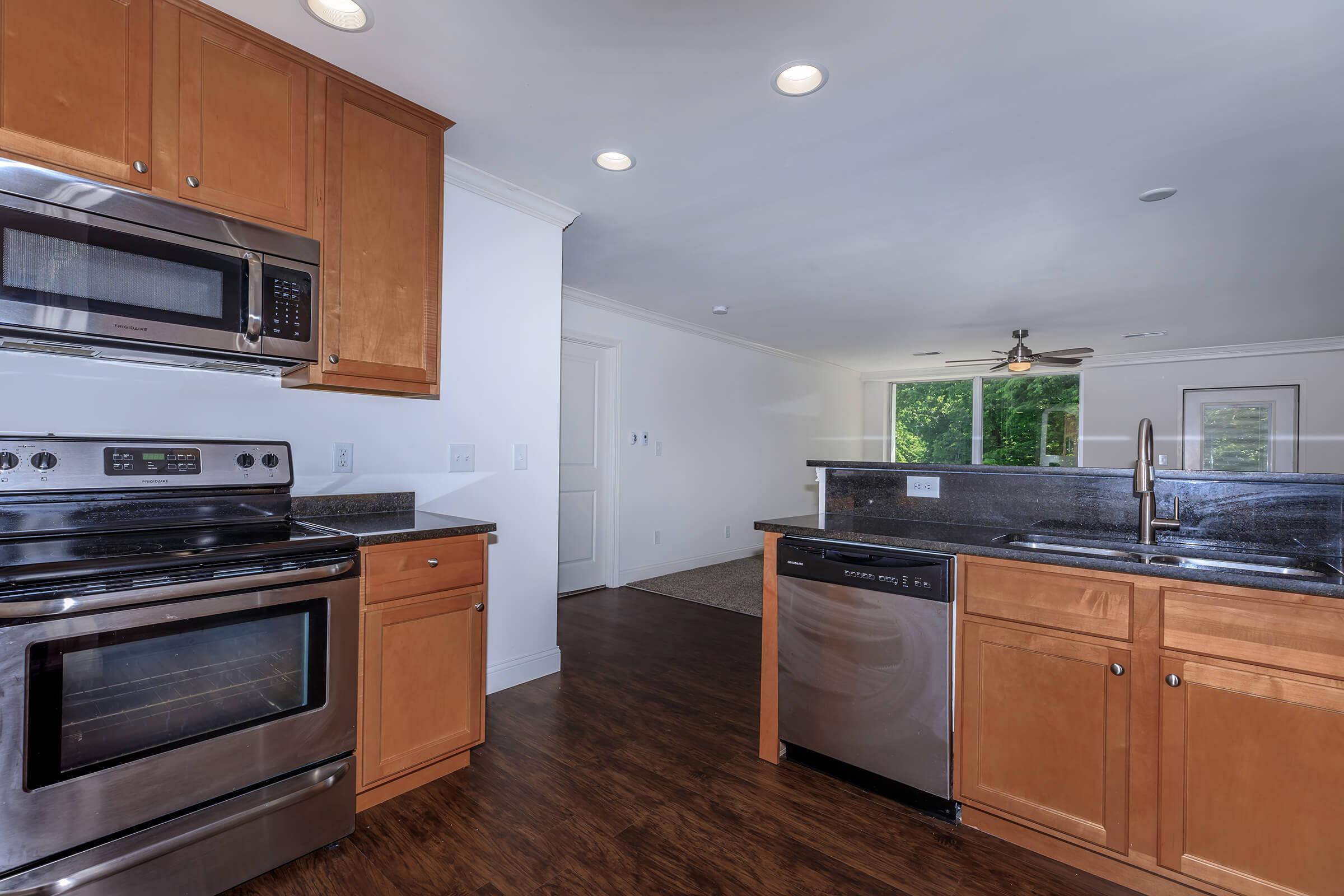 a kitchen with stainless steel appliances and wooden cabinets