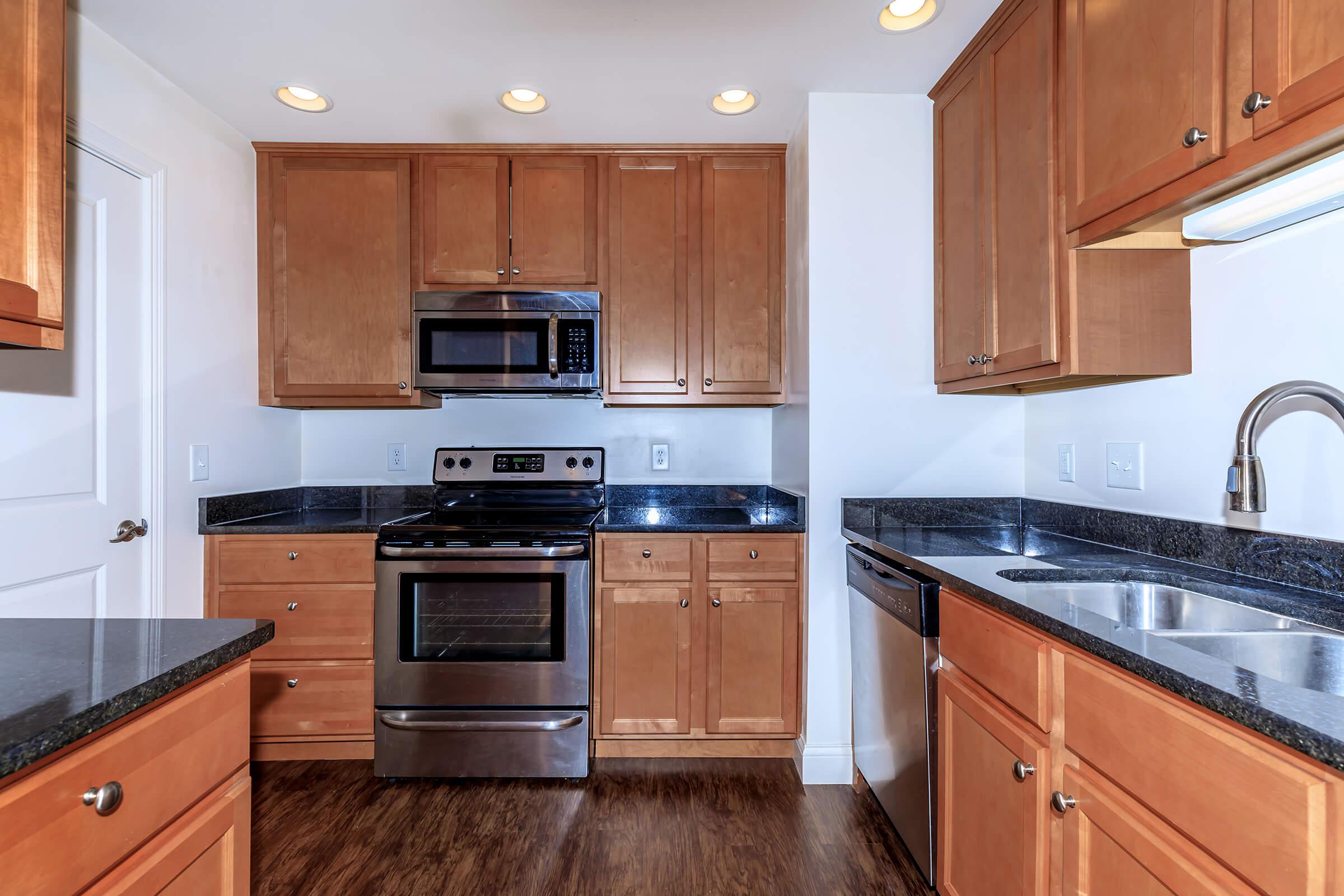 a kitchen with stainless steel appliances and wooden cabinets