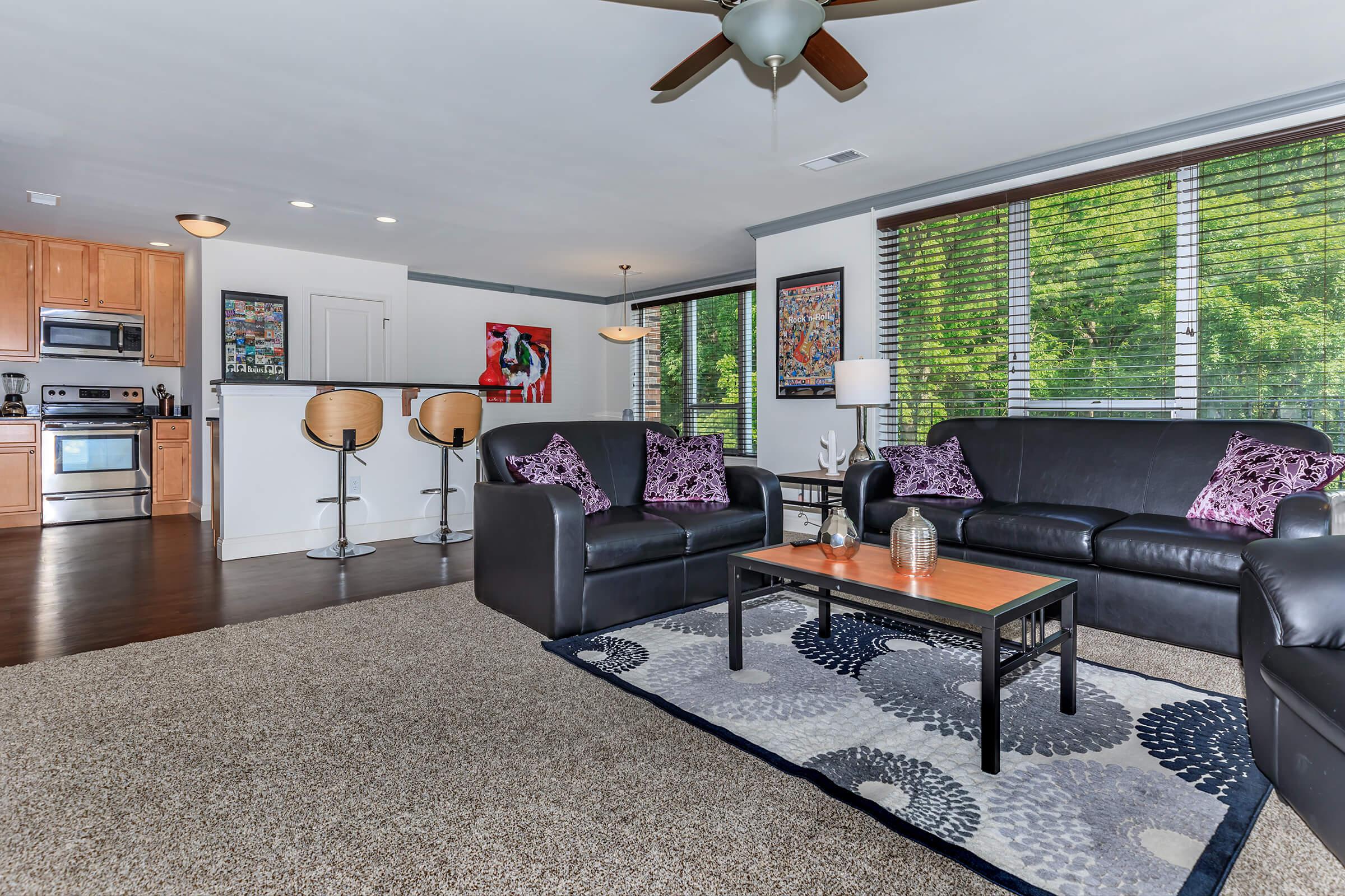 a living room filled with furniture and a flat screen tv