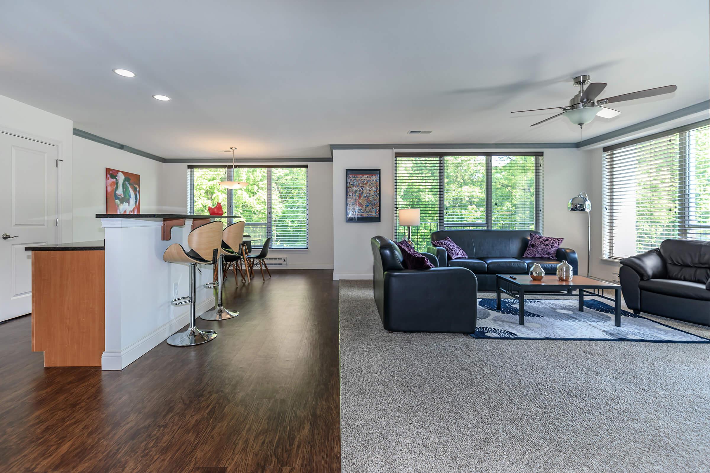 a living room filled with furniture and a large window