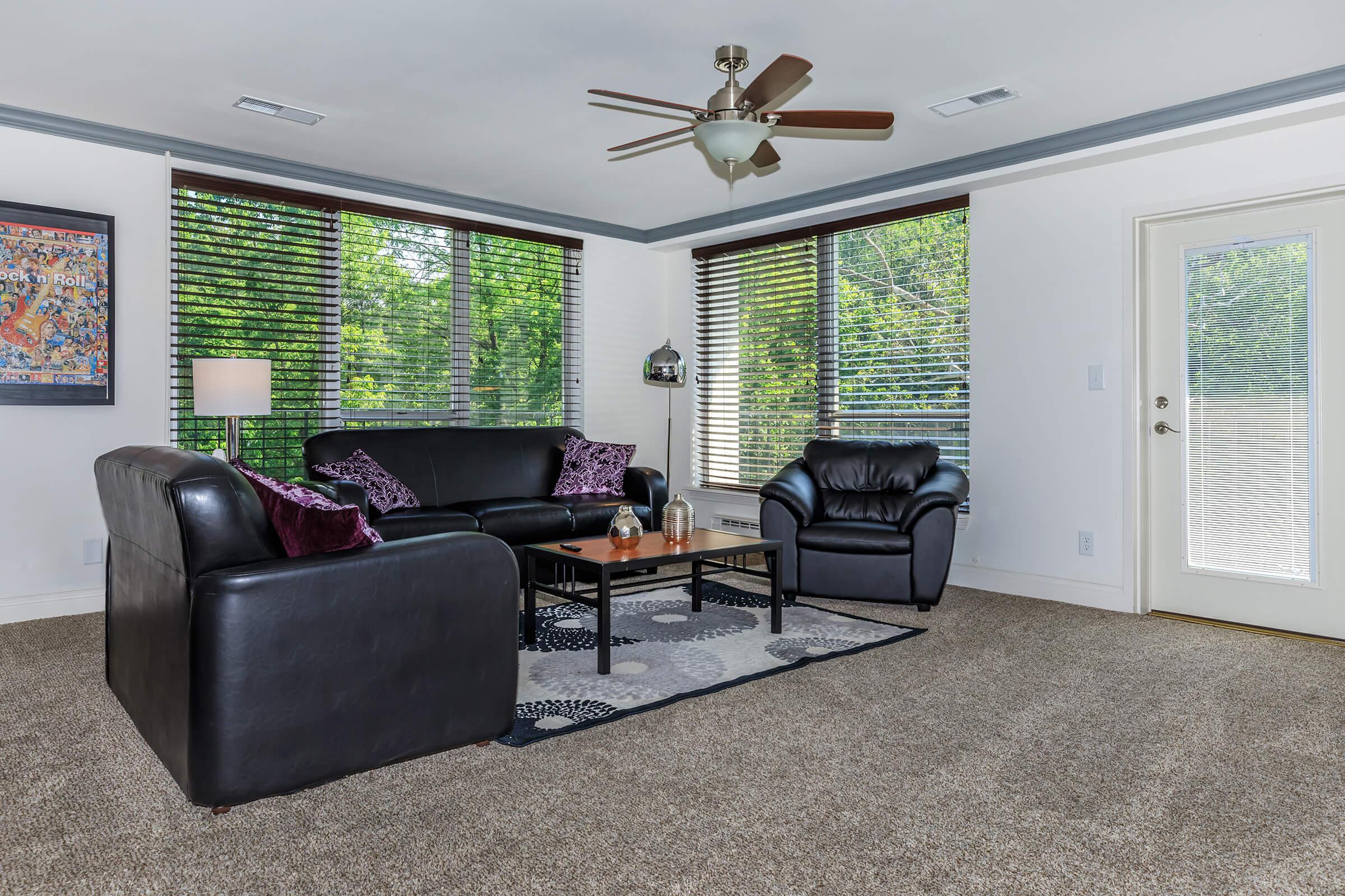 a living room filled with furniture and a large window