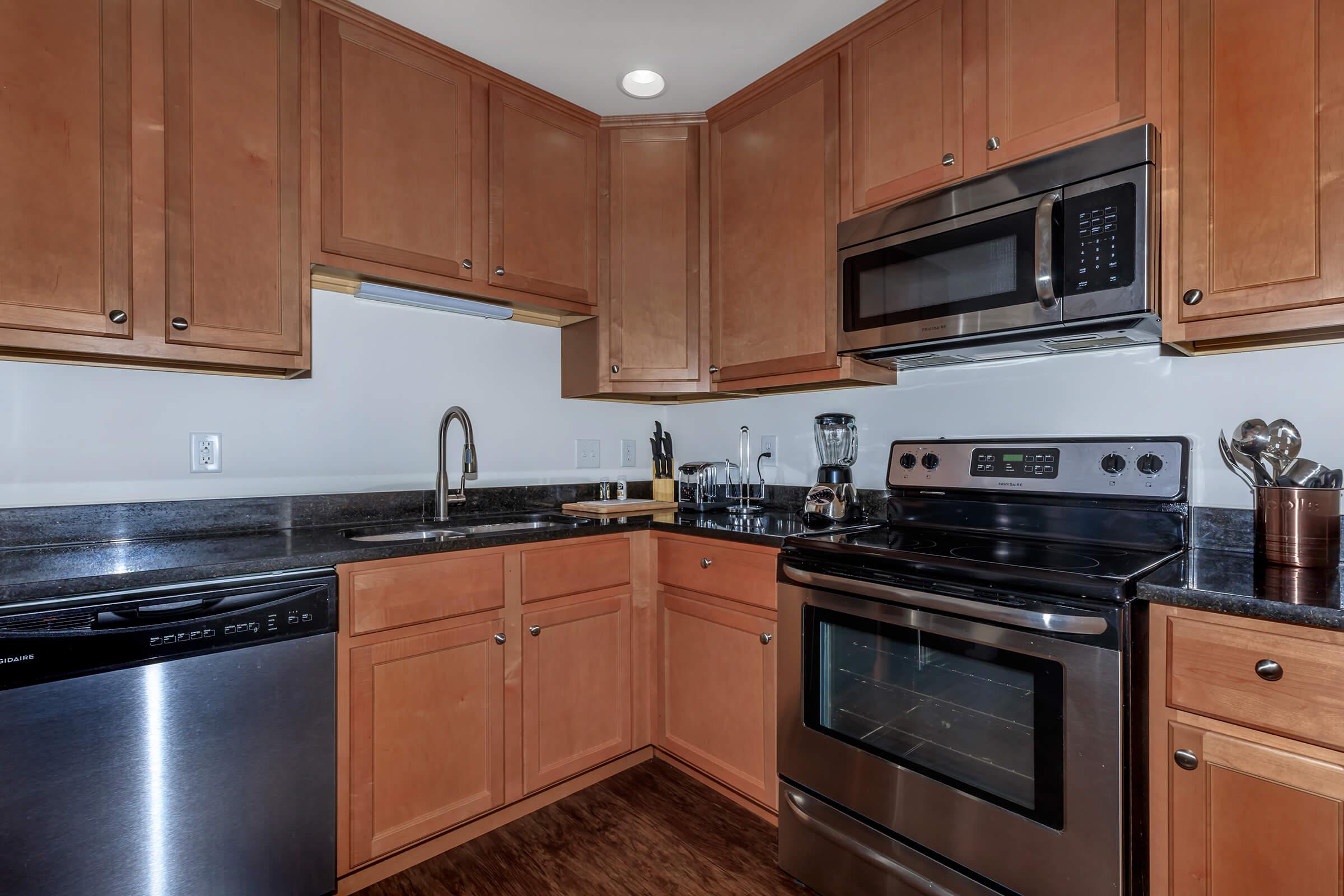 a kitchen with stainless steel appliances and wooden cabinets