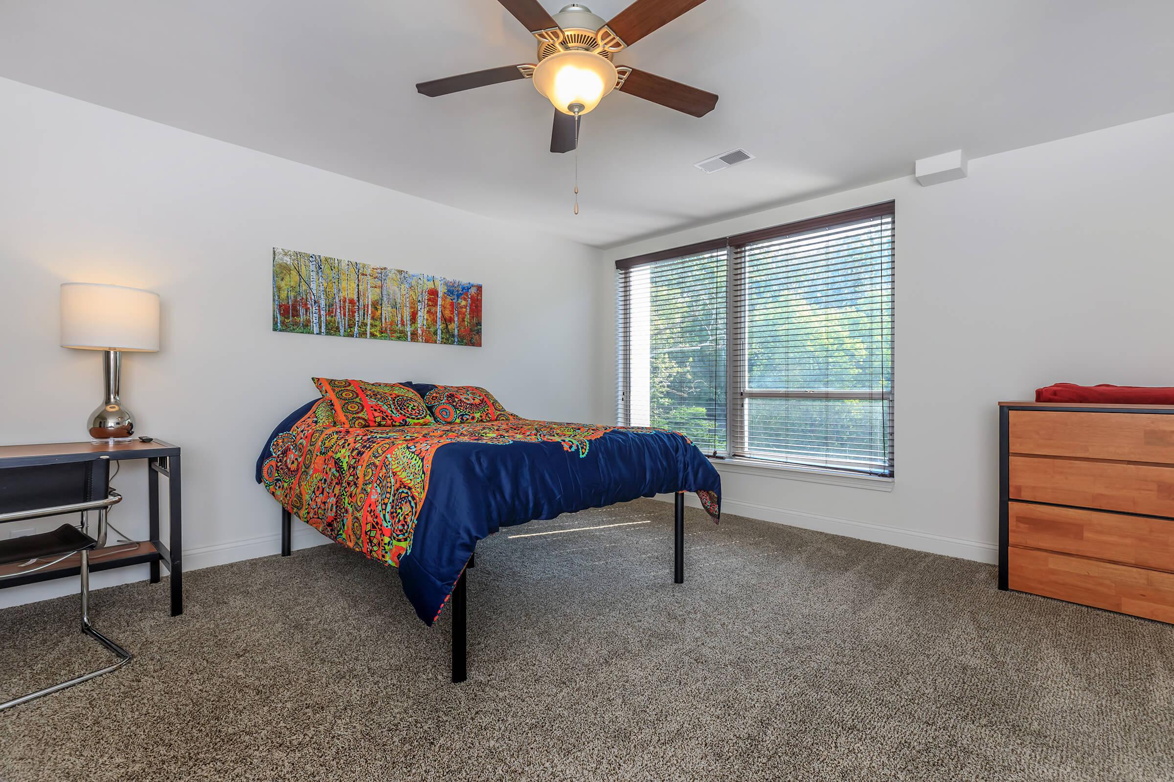 a bedroom with a bed and a couch in a living room