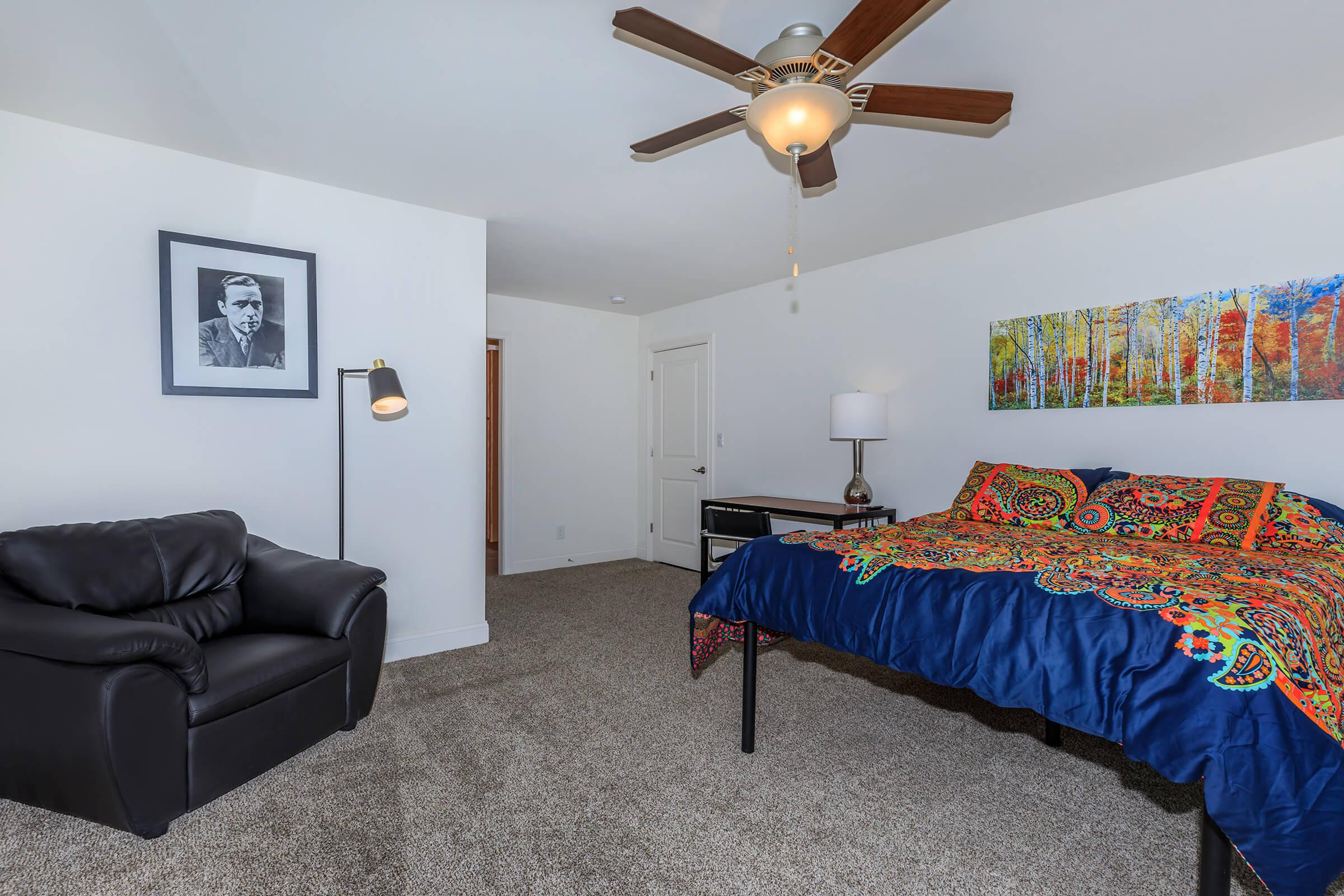 a living room filled with furniture and a bed