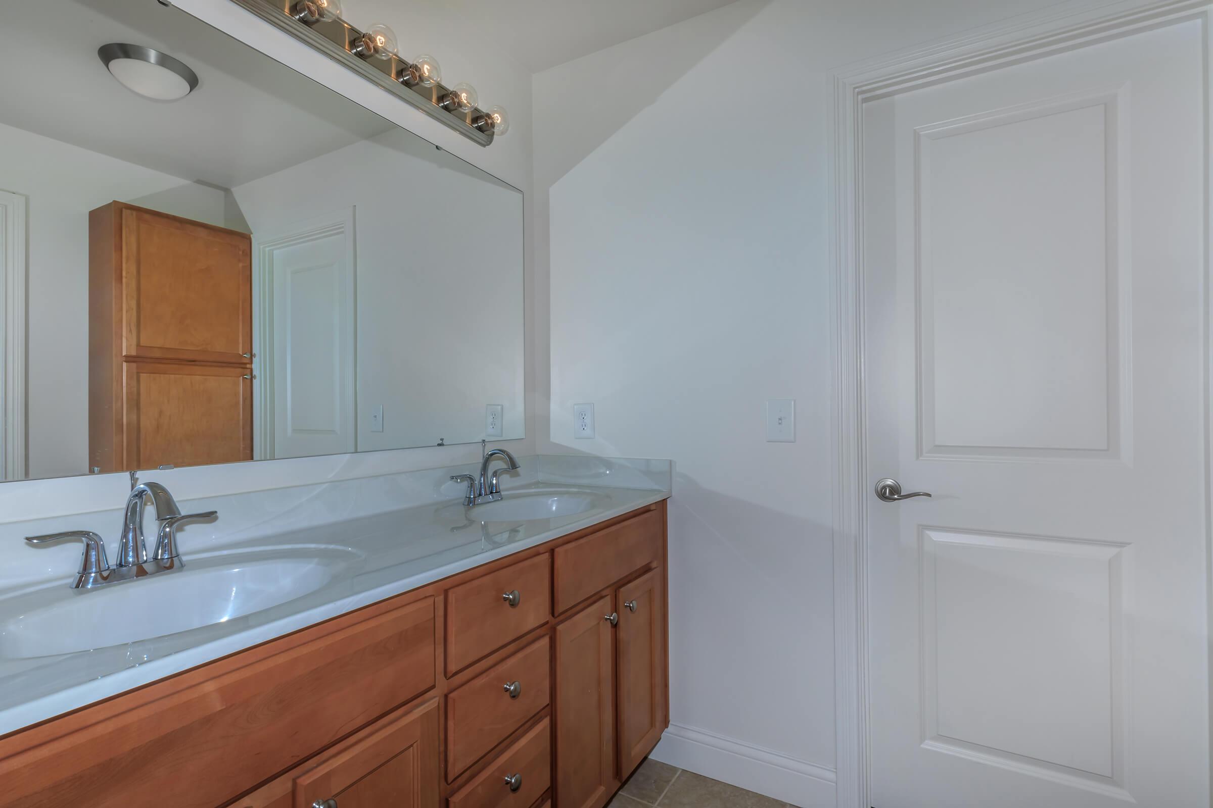 a kitchen with a sink and a mirror