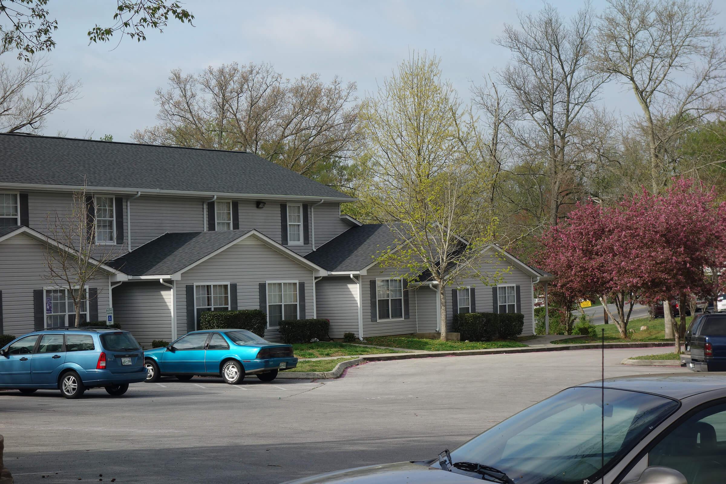 a car parked in a parking lot in front of a house