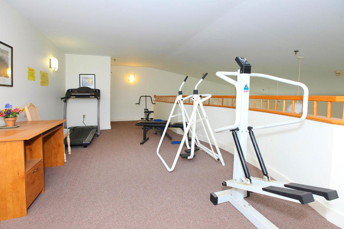 a bedroom with a desk and chair in a room