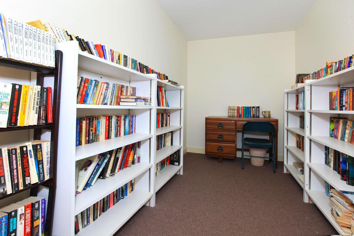 a room with a book shelf filled with books