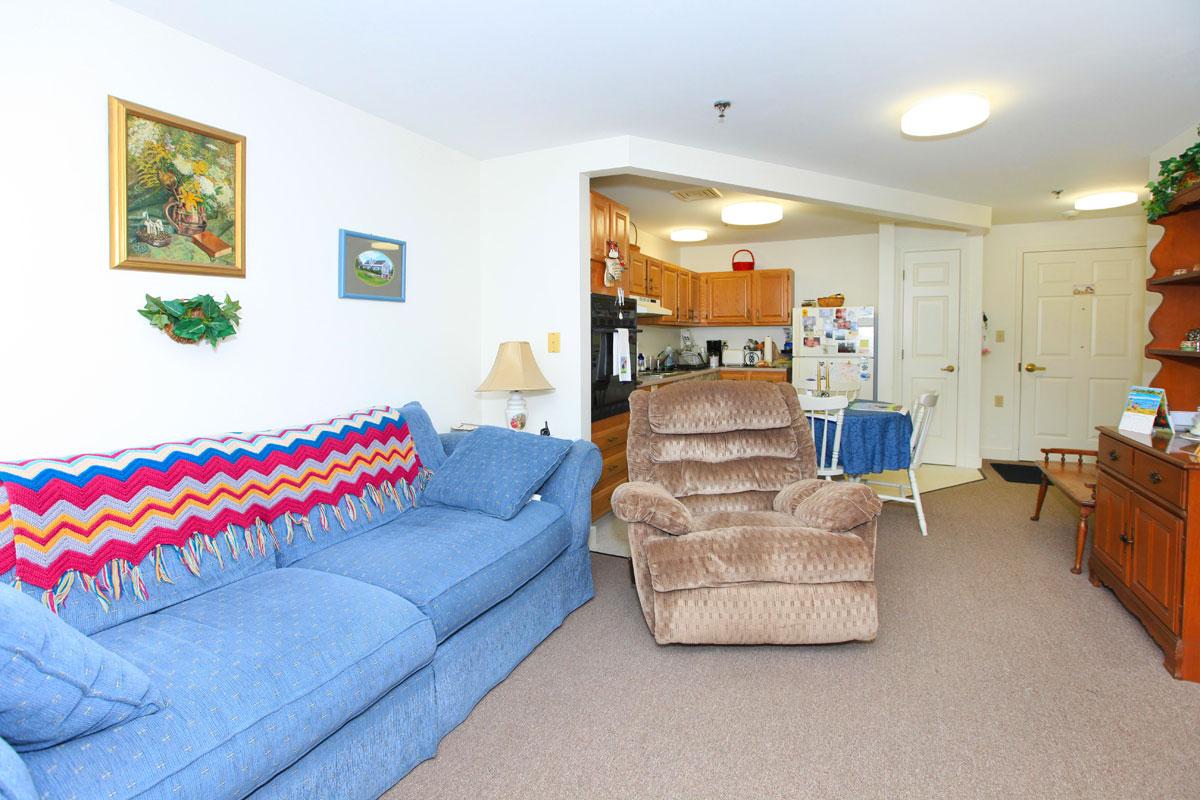 a living room filled with furniture and a bed