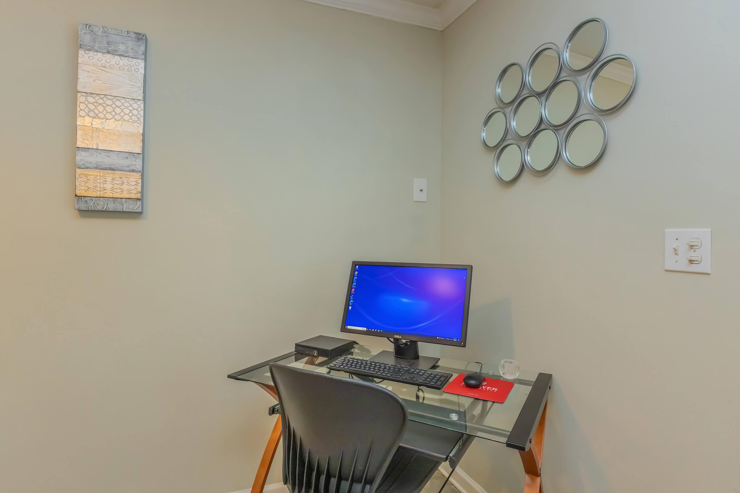 a desk with a laptop in a room