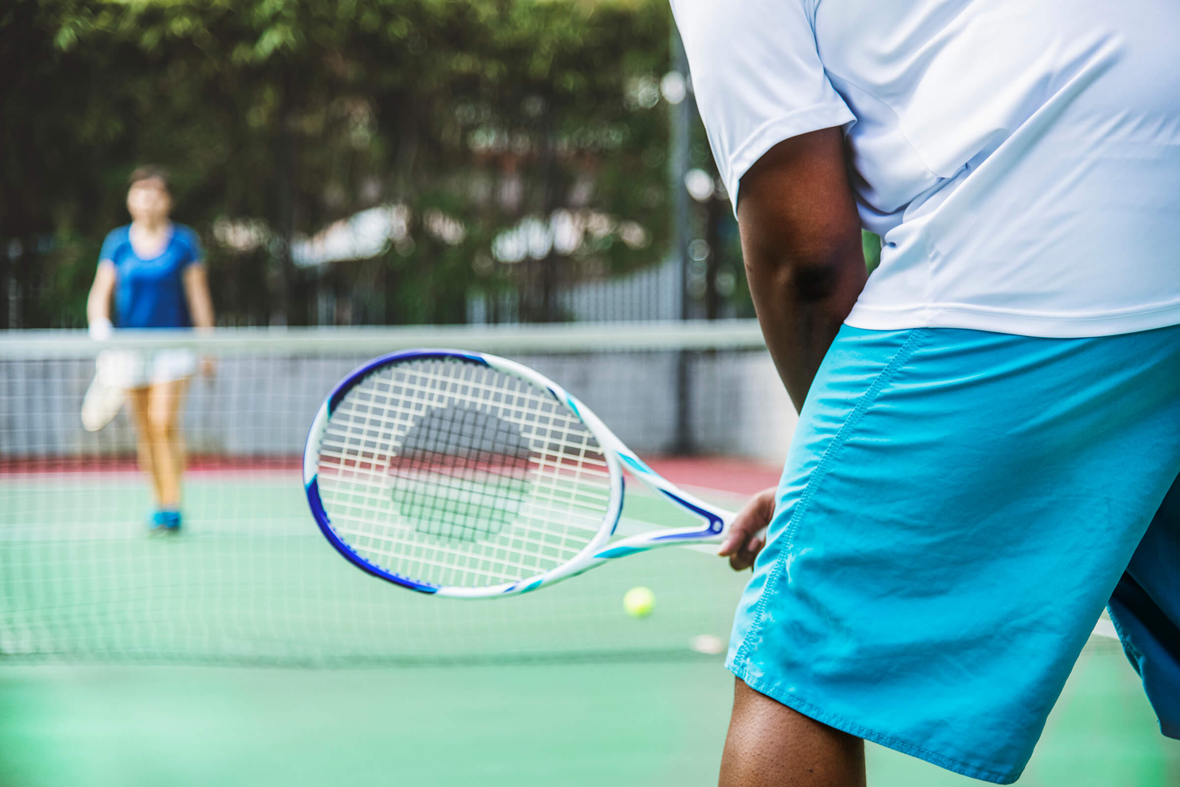 a person holding a racket on a court
