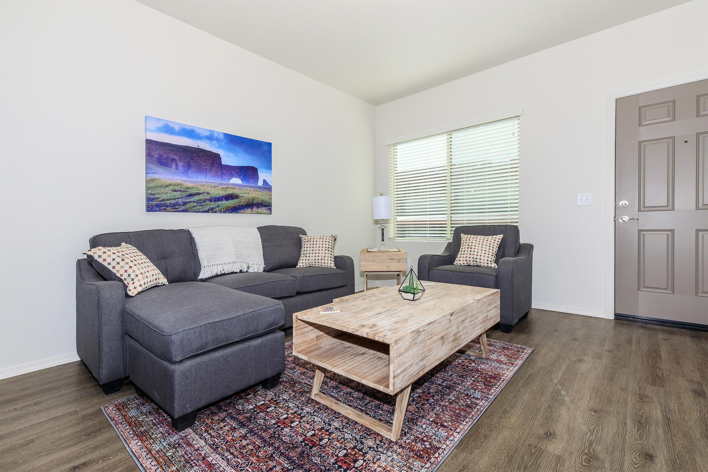 a living room filled with furniture and a tv
