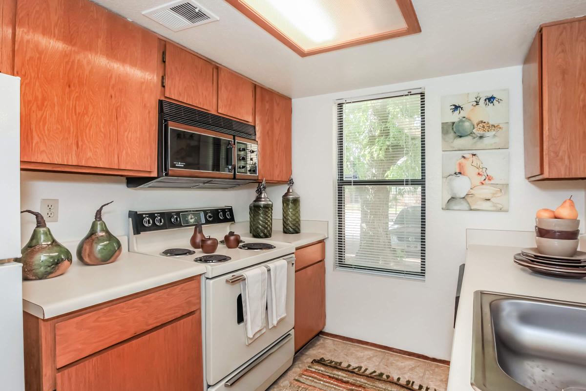 a kitchen with a stove a sink and a microwave