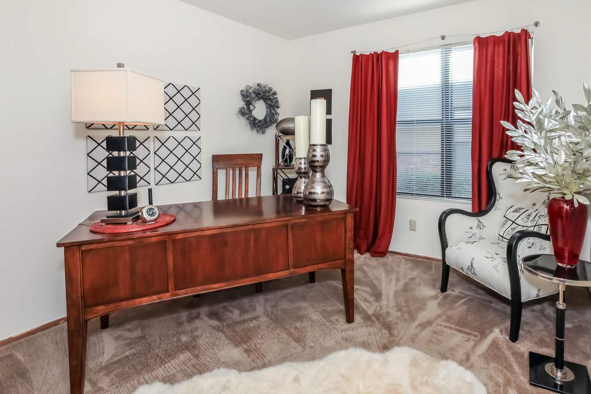 a living room filled with furniture and a red chair