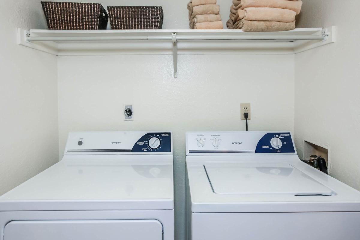 a white microwave oven sitting on top of a refrigerator