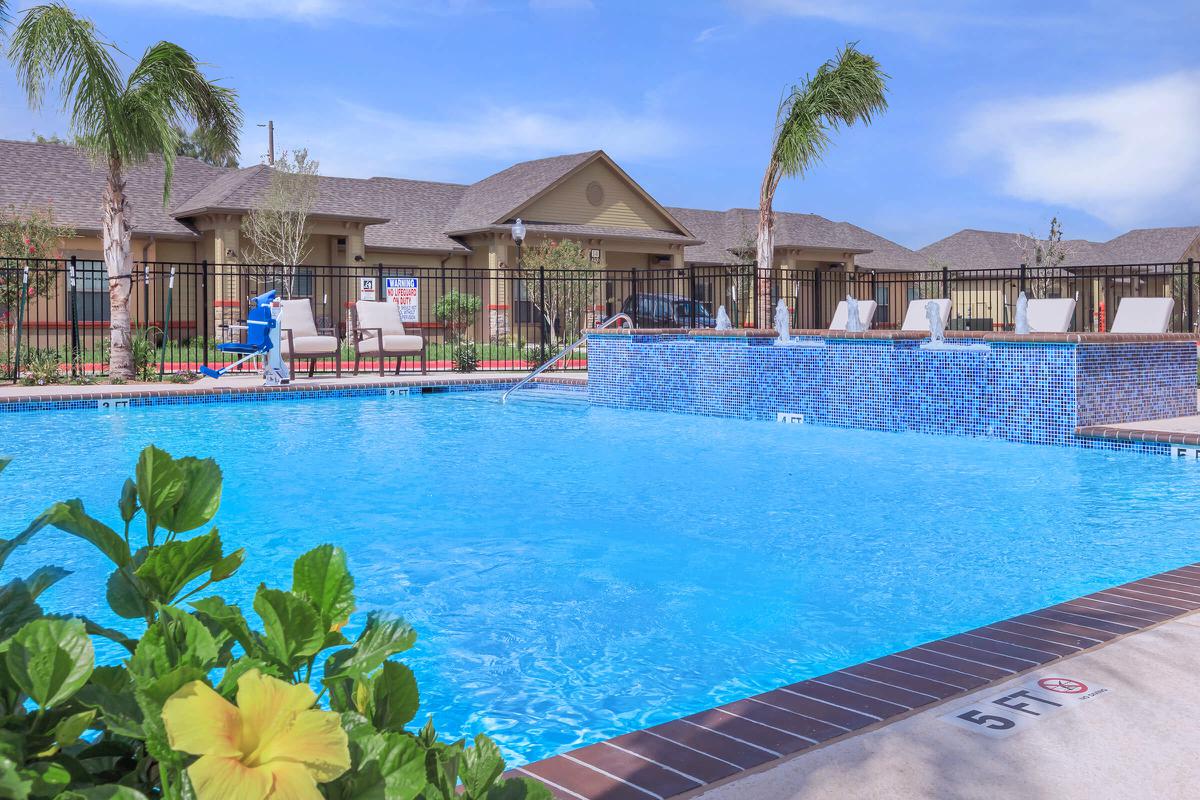 a large pool of water in front of a house