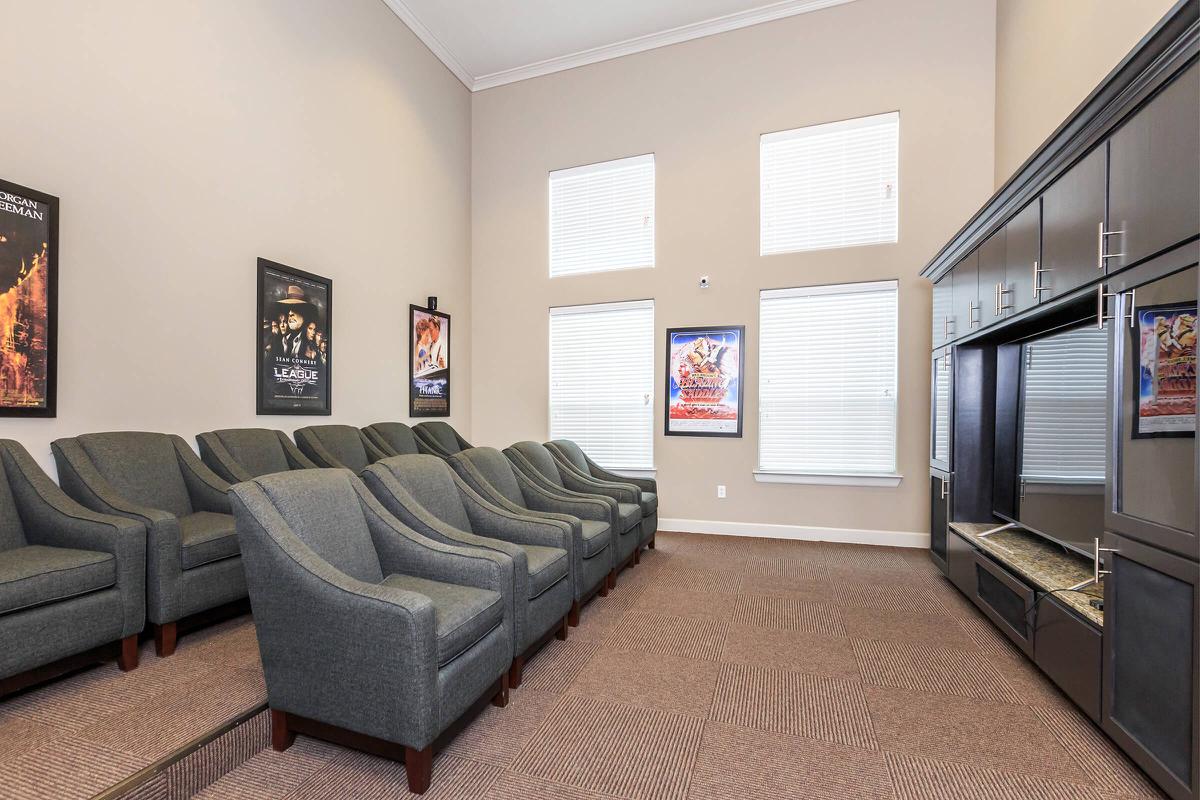 a living room filled with furniture and a large window