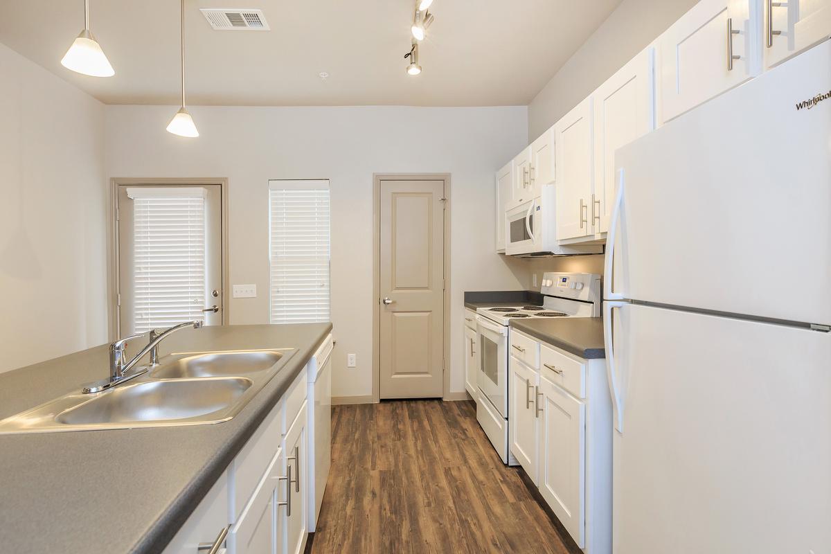 a kitchen with a sink and a refrigerator