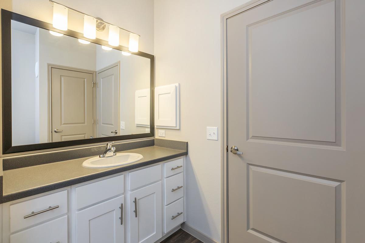 a kitchen with a sink and a mirror