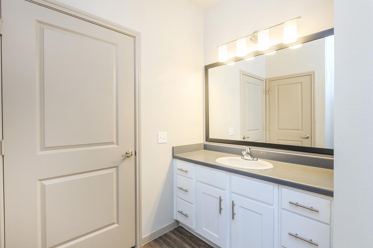 a kitchen with a sink and a mirror