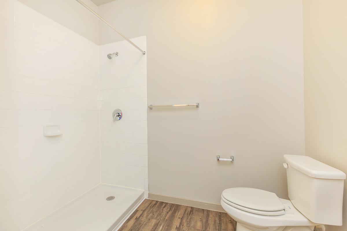 a white tub sitting next to a shower