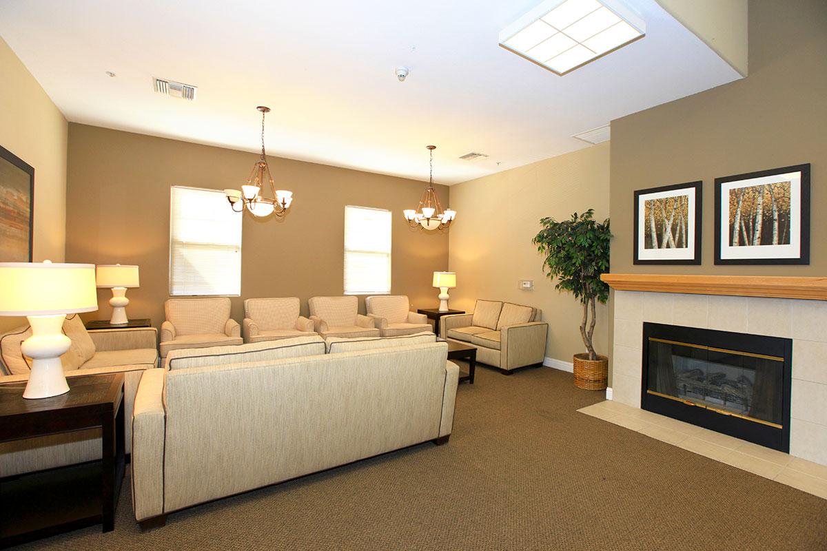 Community room with couches and a fireplace