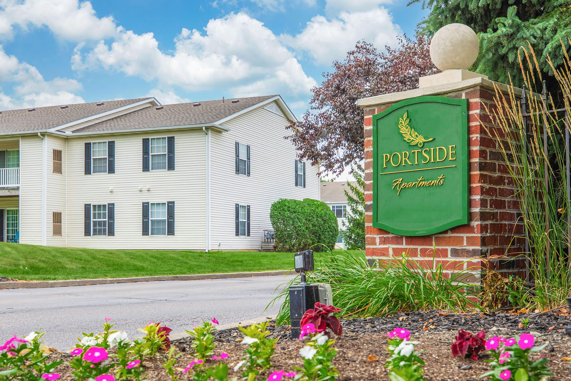 a colorful flower garden in front of a house