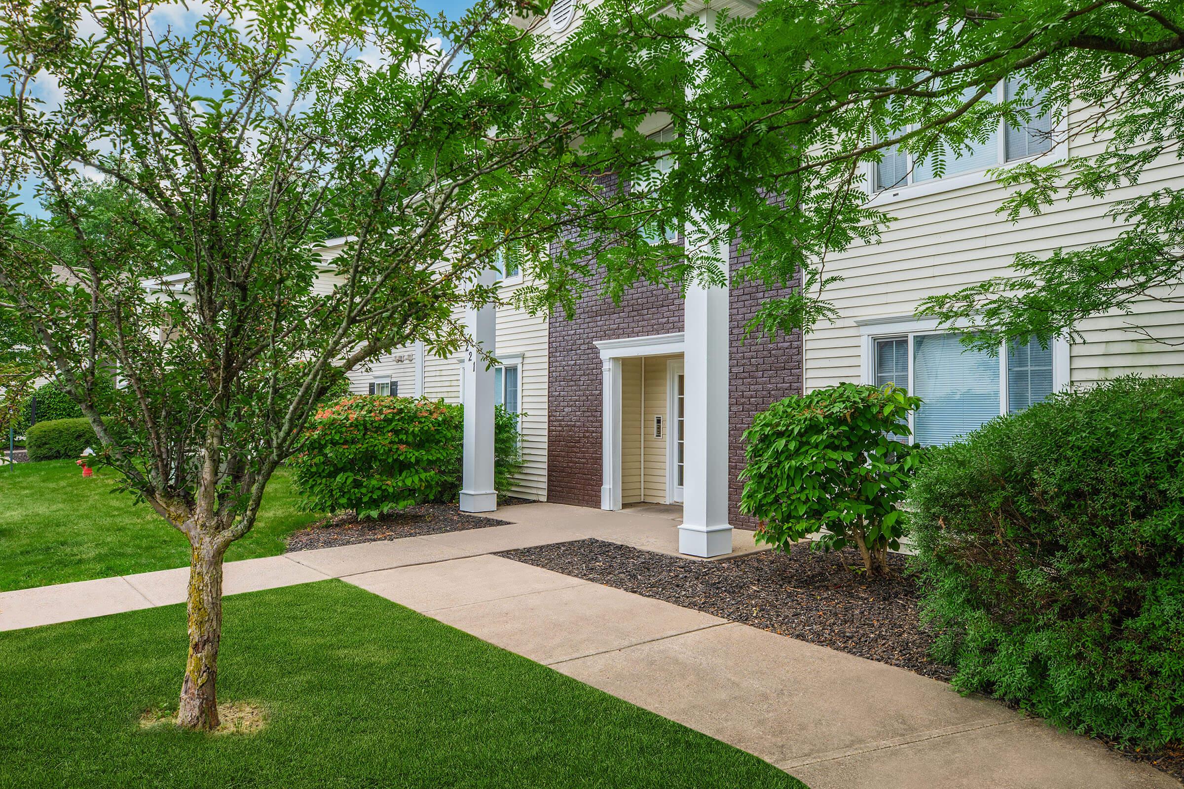 a tree in front of a house