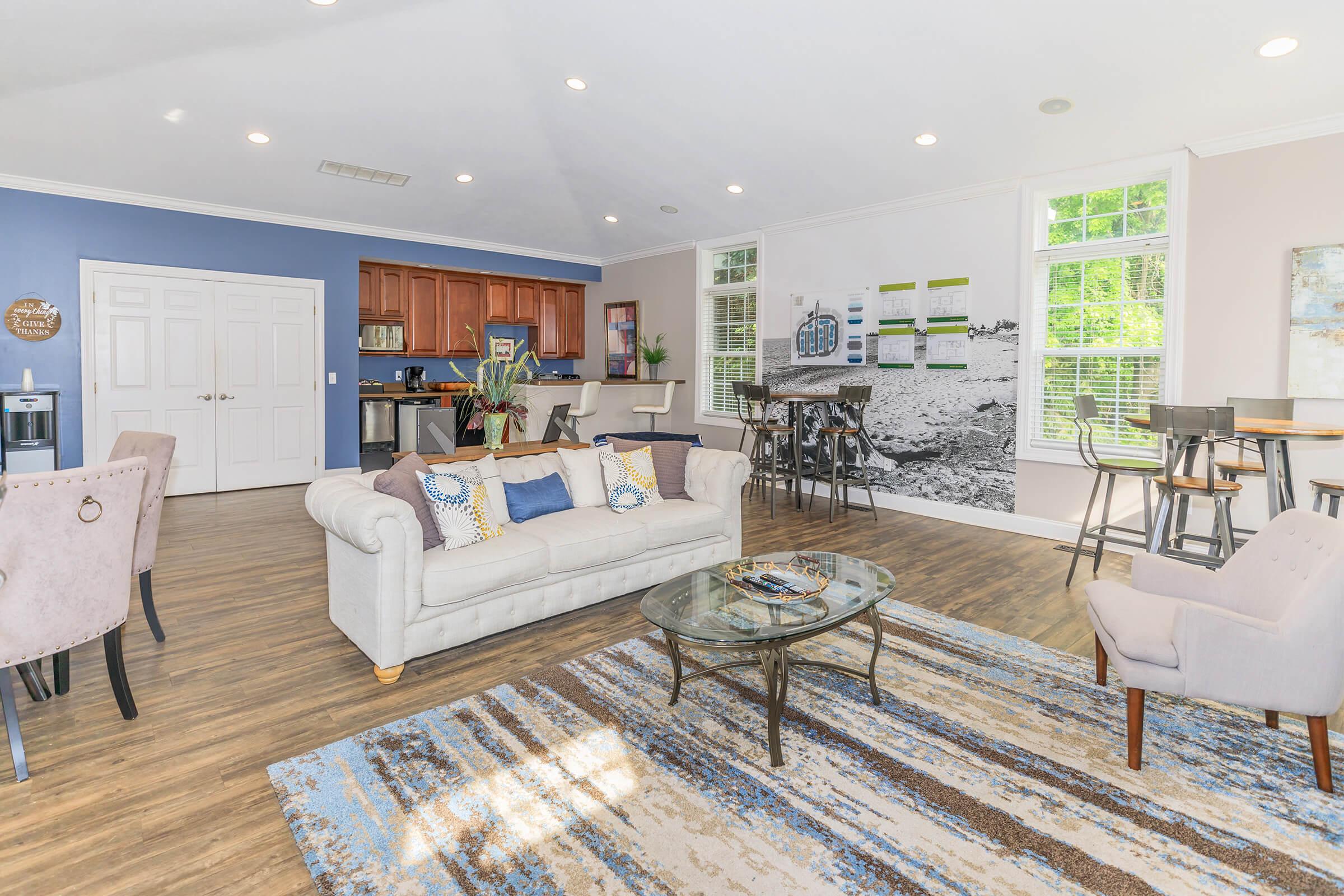 a living room filled with furniture and a large window