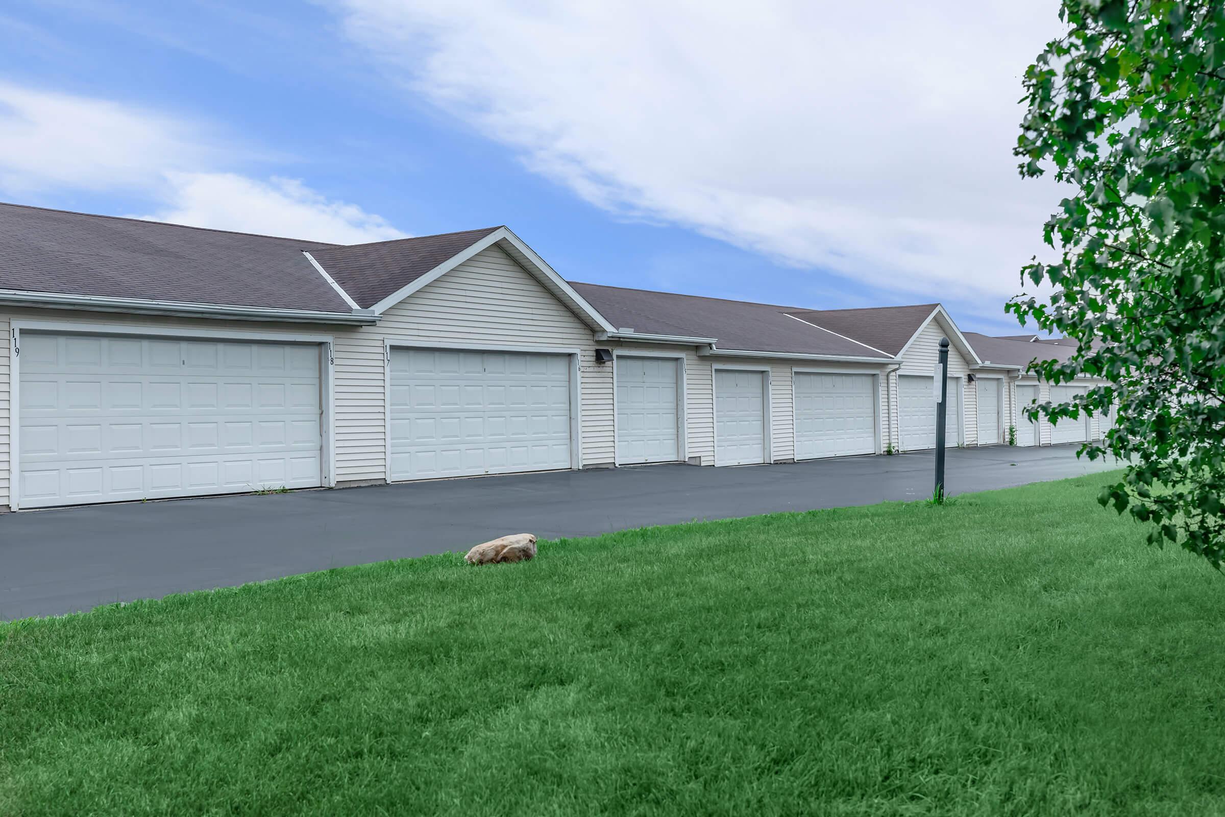 a herd of sheep grazing in front of a house