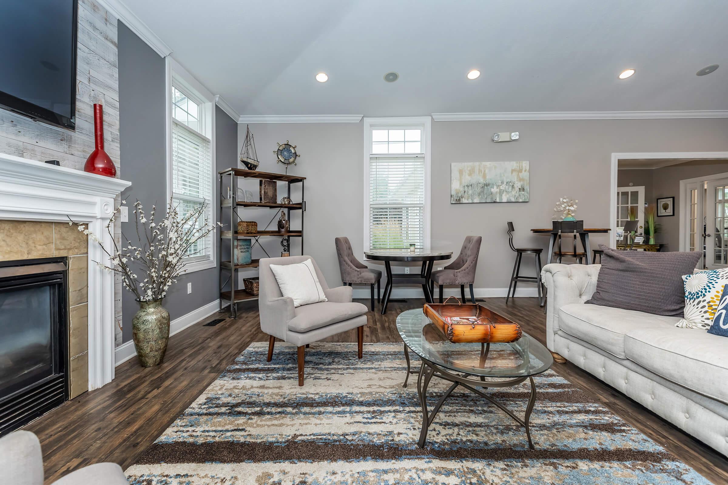 a living room filled with furniture and a flat screen tv