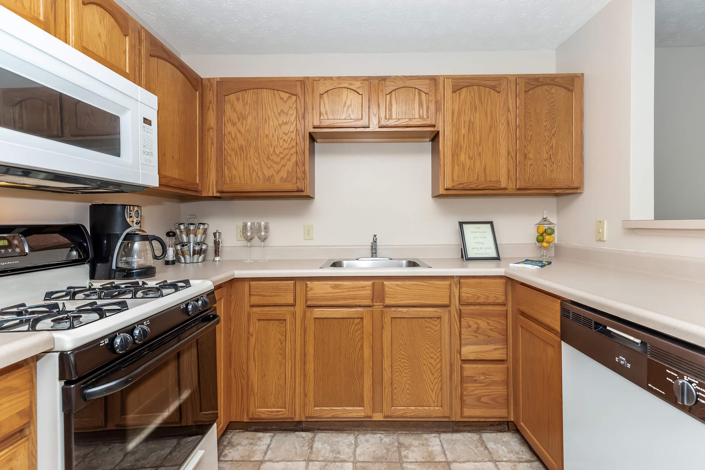 a kitchen with a stove a sink and a microwave