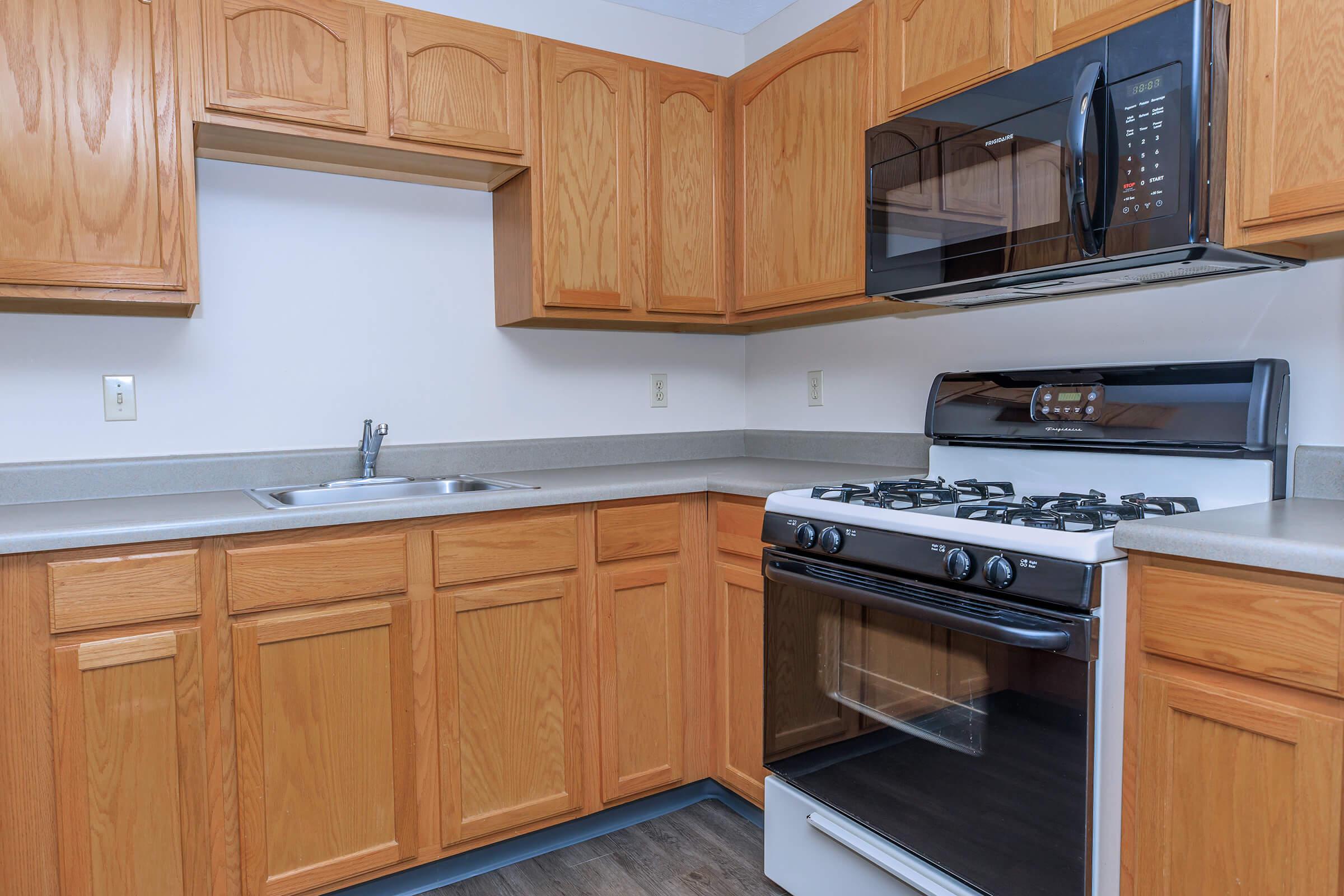 a kitchen with stainless steel appliances and wooden cabinets