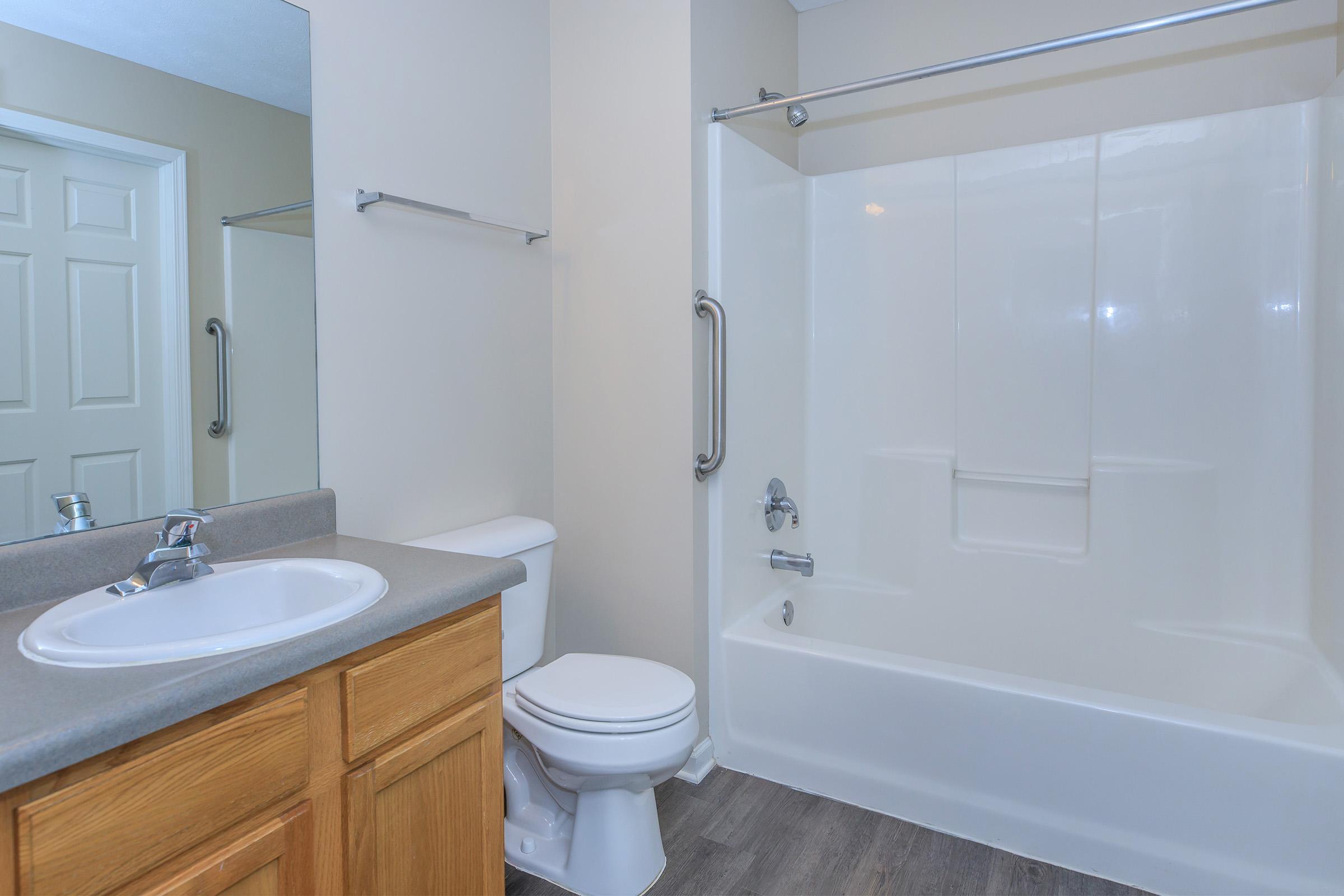 a shower that has a sink and a mirror