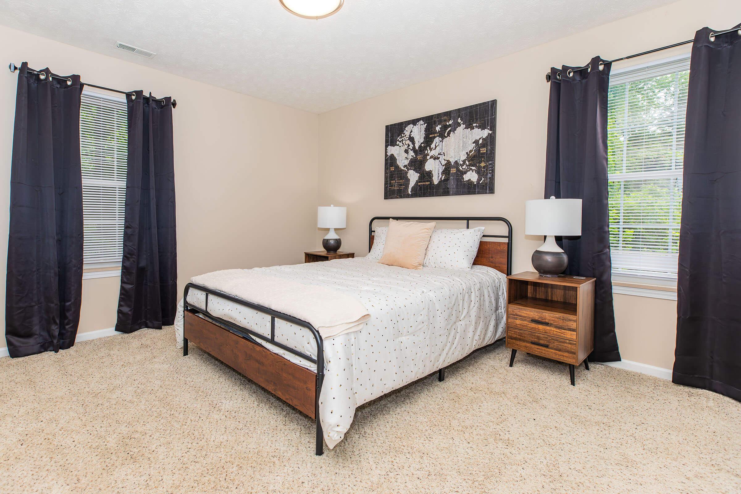 a bedroom with a bed and desk in a room