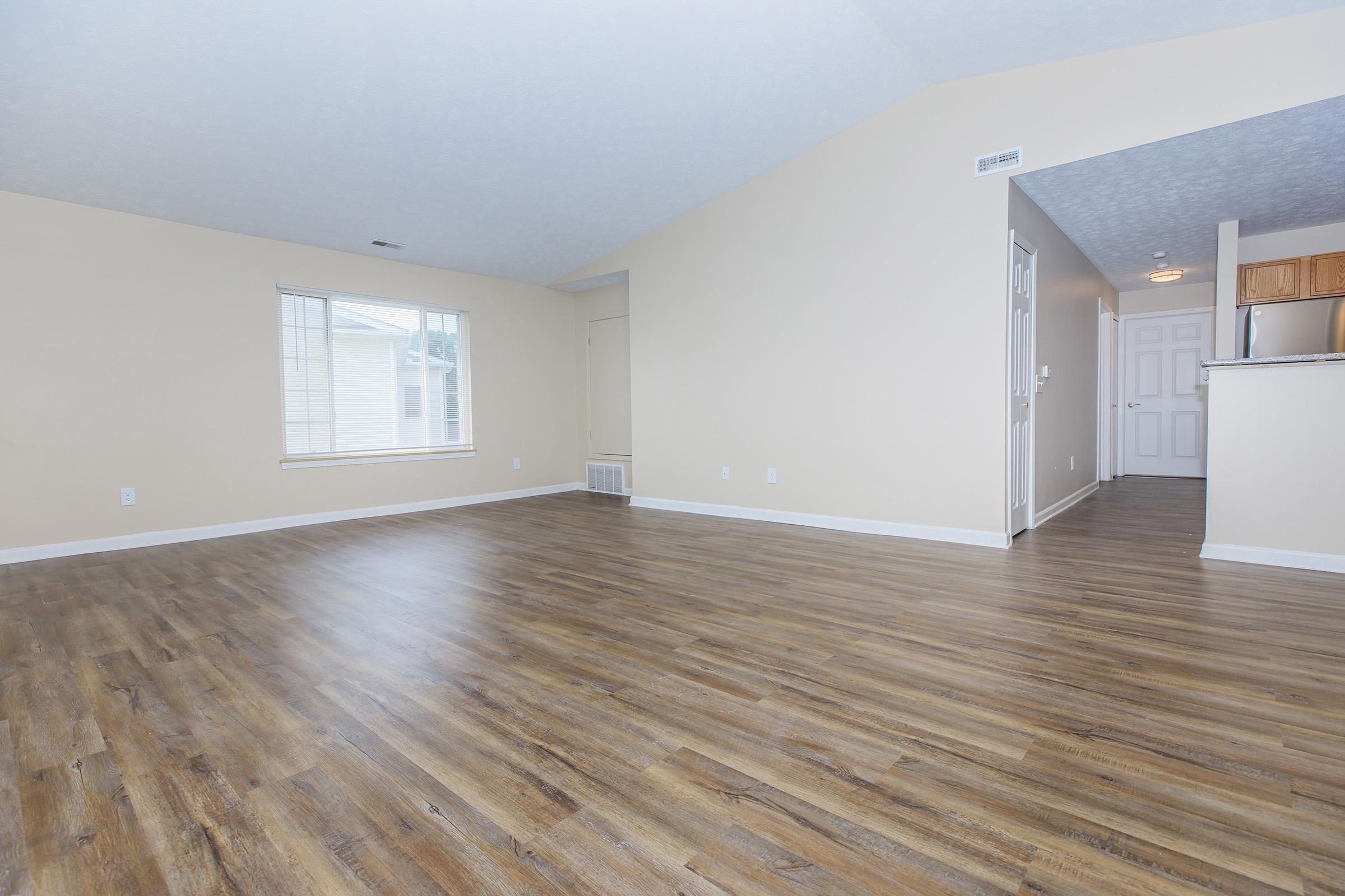 a large empty room with a wooden floor