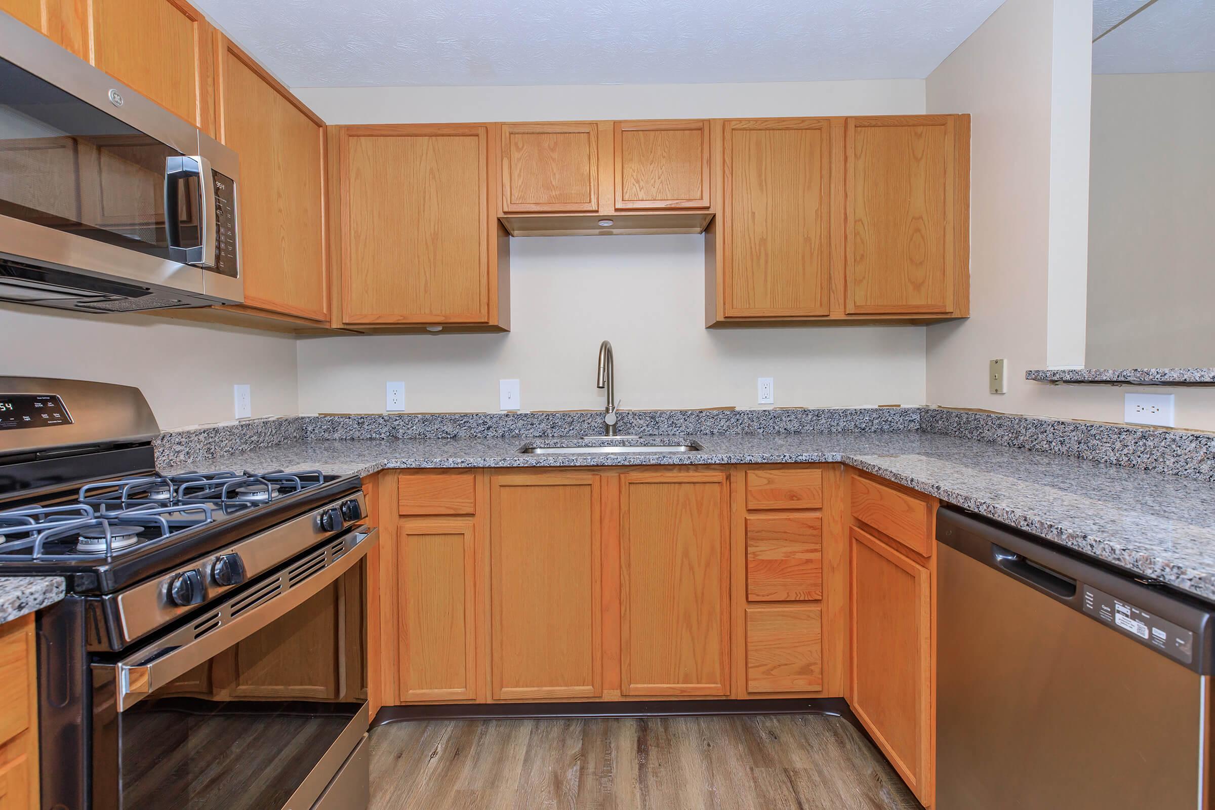 a kitchen with stainless steel appliances and wooden cabinets