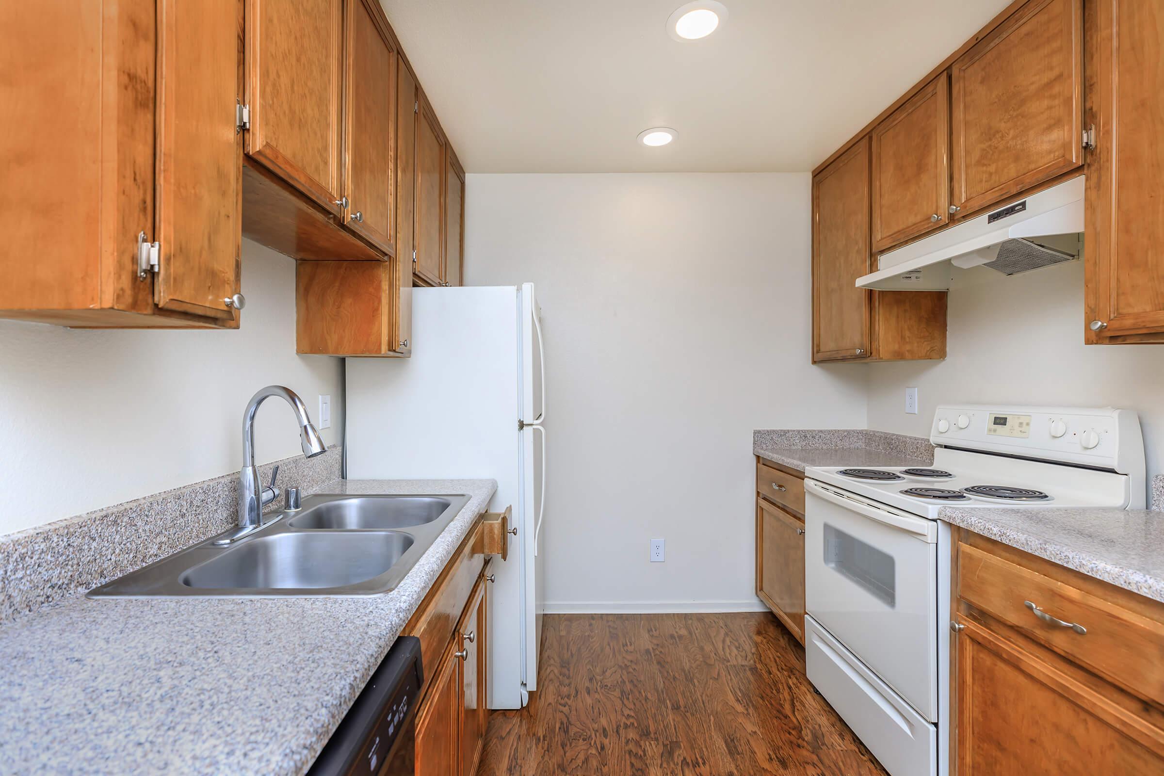 a kitchen with stainless steel appliances and wooden cabinets