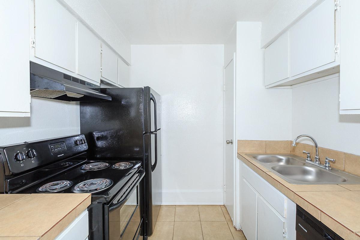 a stove top oven sitting inside of a kitchen