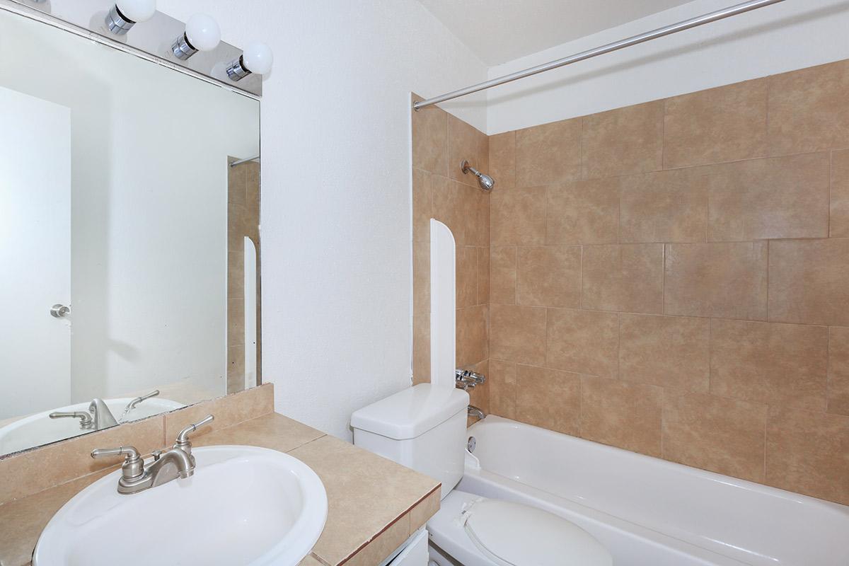 a large white tub sitting next to a sink