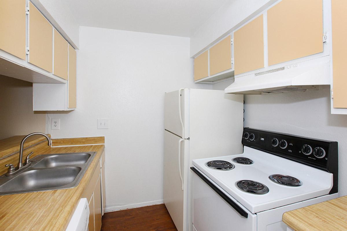 a white stove top oven sitting inside of a kitchen